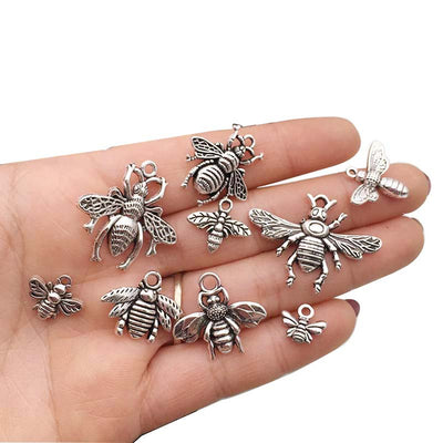 Gold-tone bee charms arranged on a light background