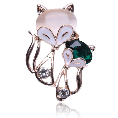 Rose gold fox brooch with cat-eye head and green crystal body close-up