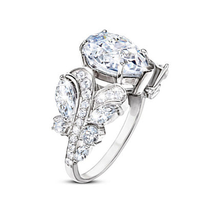 Silver pear teardrop clear ring side angle with swirl wing