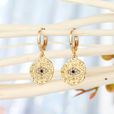 Main product view of hamsa and Evil Eye Medallion Huggie Drop Earrings in Four Finishes