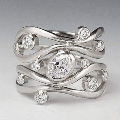 Front silver wave multi-band oval clear CZ geometric ring gray backdrop