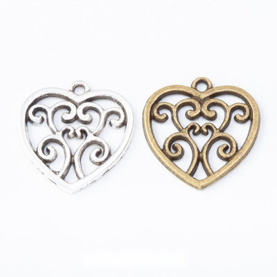 Group view of a heart outline encloses mirrored vine-like scrollwork