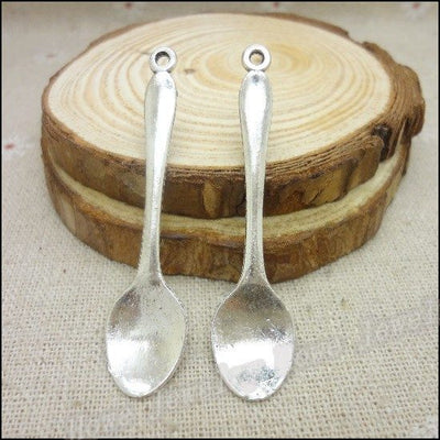 Product photo 1 of the long handle spoon charm highlighting its plain miniature spoon with a loop at the handle end