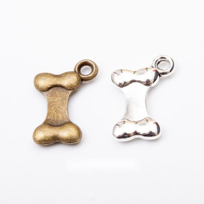 Grouped front view of rounded dog bone charms in the available finishes