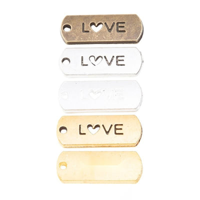 Group view of love heart cutout tag charm on a white background