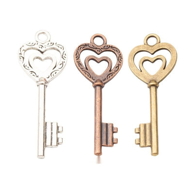 Heart top key charm shown across the available finishes