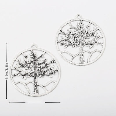 Overview of the large round tree charm in the available metal finishes