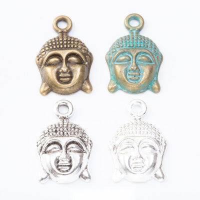 Product view of Buddha head charm showing a serene Buddha head with textured hair, elongated ears, and a top loop