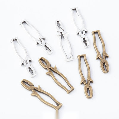 Group view of the pliers charm showing the available finishes and front details