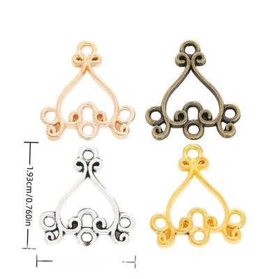 Ornate chandelier connectors with one top loop and five lower loops arranged together on a white background.