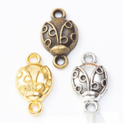 Beetle Setting Connector finish comparison showing a beetle-shaped openwork frame with an oval recessed setting