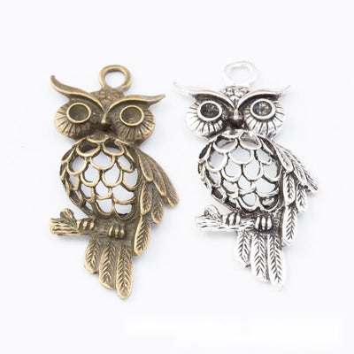 Openwork Owl Metal Charm Connectors in multiple metallic finishes displayed together on a white background.