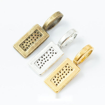 Rectangular glue-on pendant bail with a textured face shown across the available finishes