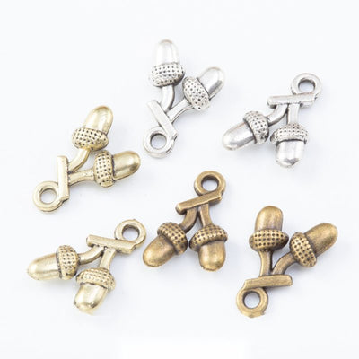 Front comparison of pair of acorns metal component in 3 finishes