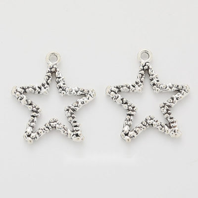 Front-facing arrangement of star and crescent moon charms on a white background