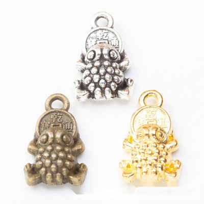 Grouped front views of money toad charms