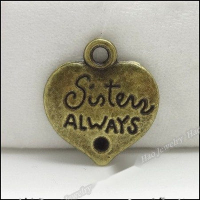 Group view of small heart pendant embossed with Sister Always and a tiny heart