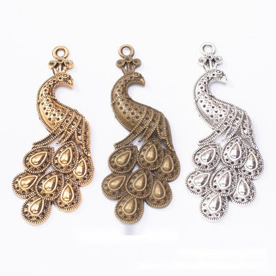 Front comparison of ornate peacock metal component in 3 finishes