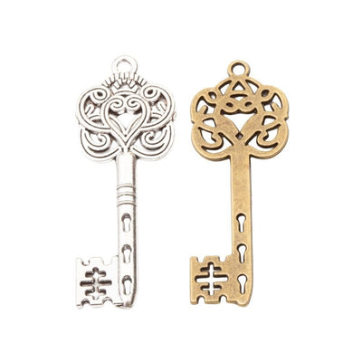 Ornate Key Charm Pendant finish comparison showing a pierced floral bow and decorative bit
