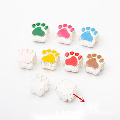 Product view of paw print bead showing a silver-tone paw-shaped large-hole bead with a glossy colored enamel face