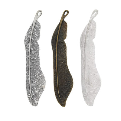 Group view of slim curved feather charm on a white background