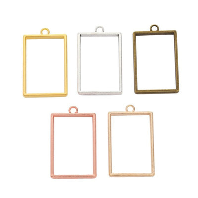 Rectangular open bezel pendant shown across the available finishes