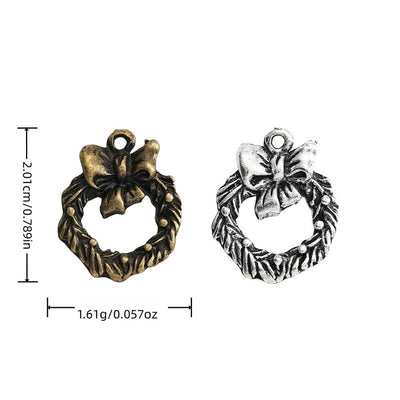 Grouped front views of the bow wreath charm in available finishes