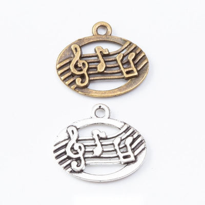 Front view of oval music staff charm showing finish variation 1
