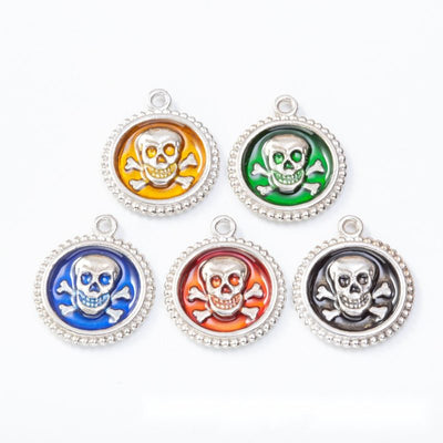 Skull and Crossbones Enamel Round Metal Charms in multiple metallic finishes displayed together on a white background.