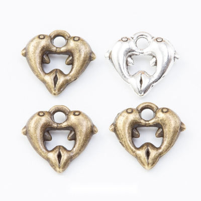 Group view of open heart frame holding two inward-facing dolphins