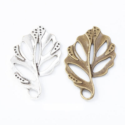 Group view of openwork split leaf with engraved veins and a top loop