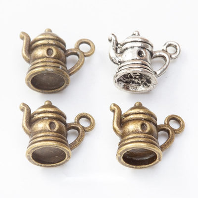 Miniature Teapot Metal Charms in Two Antique Finishes in multiple metallic finishes displayed together on a white backgr