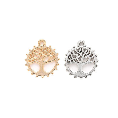 Assorted round tree of life charms arranged together on a white background
