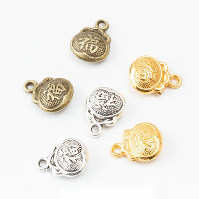 Fortune Pouch Charm grouped finish options on a white background