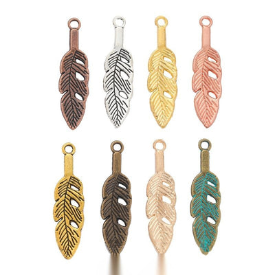 Product photo 1 of the openwork feather charm highlighting its slender feather with open barbs and a top loop