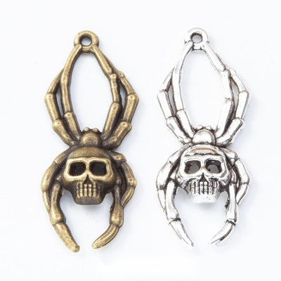 Grouped front view of skull spider connector showing a skull body, angular legs, and loops at both ends