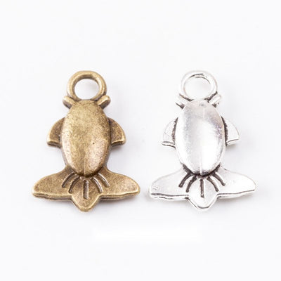 Group view of small fish figure resting over a sculpted lotus leaf