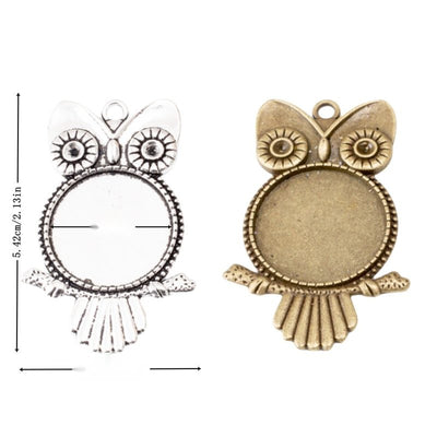 Group view of an owl-shaped metal frame surrounds a round recessed cabochon tray