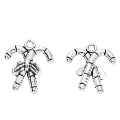 Front-facing arrangement of crossed candy canes charms on a white background