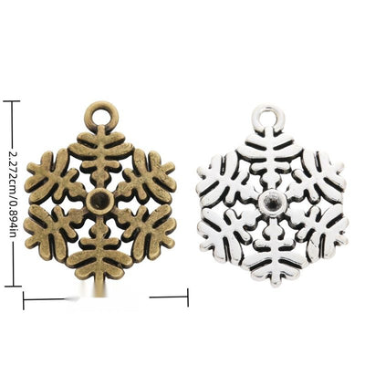 Group view of a six-armed snowflake has rounded openwork branches and a top loop