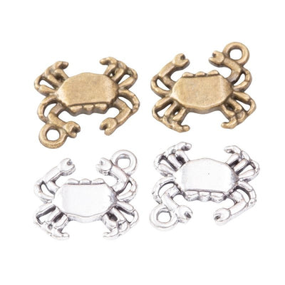 Rounded crab charms with raised claws, legs, and smooth center panels arranged together on a white background.