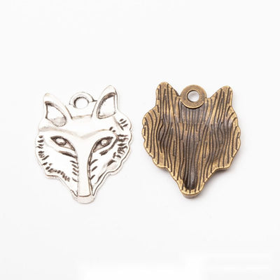 Front and finish comparison of wolf head charm