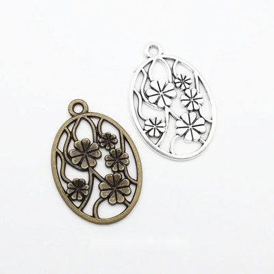 Finish comparison of 椭圆镂空花卉 charm on a white background
