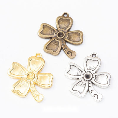Assorted four leaf clover charms arranged together on a white background