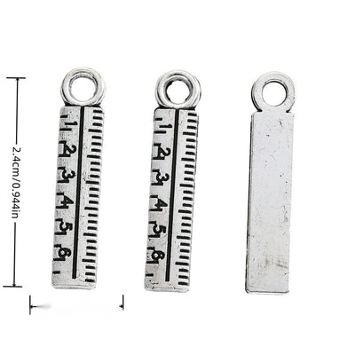 Front-facing arrangement of ruler charms on a white background
