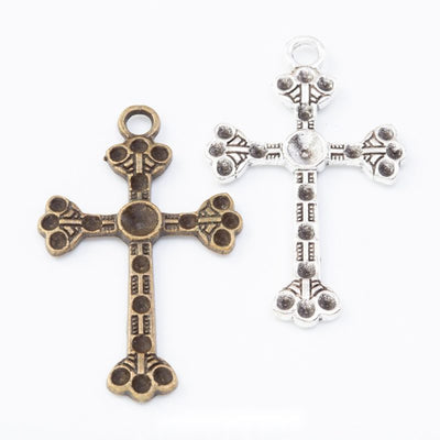 Grouped front view of dotted cross charms in the available finishes