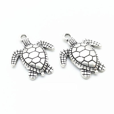 Sea Turtle Charm shown in all pictured finishes on a white background