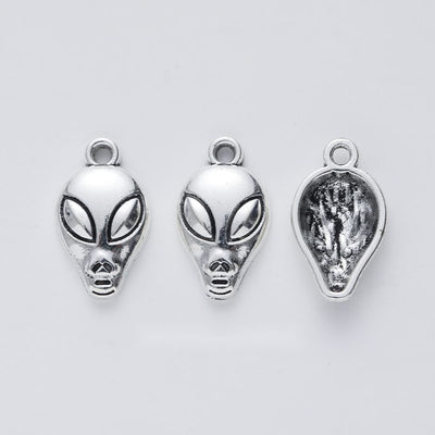 alien head metal charm shown from the front in the available metallic finishes