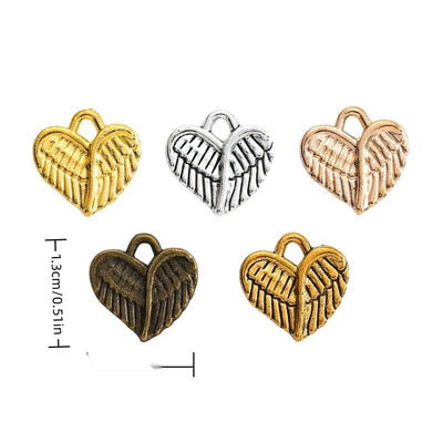 Product photo 1 of the feathered wing heart charm highlighting its heart formed by layered feathered wings