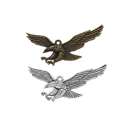 Overview of spread-wing eagle charm pieces on a white background